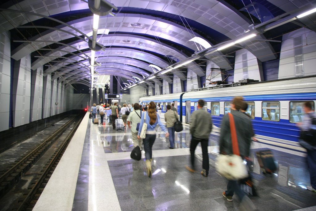 People and a train at metro station